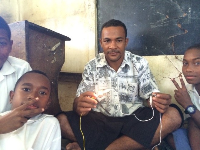 Teacher and students using the new electronics kit.
