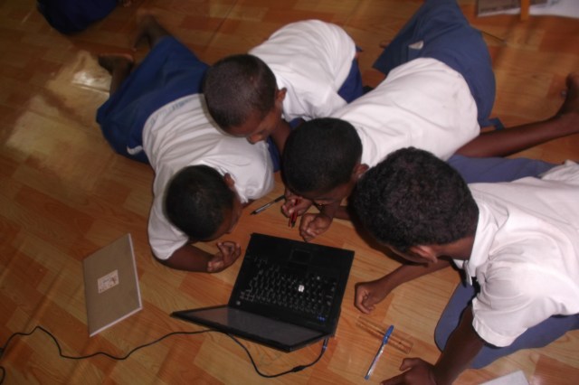 Children using  laptops for school work