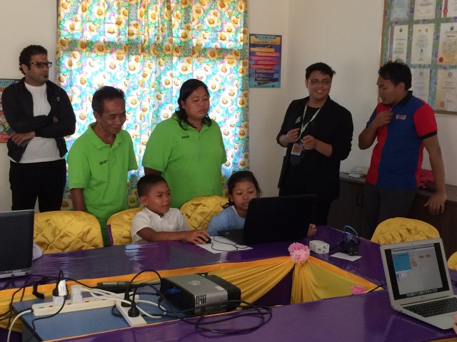Parents (in green t-shirts) listening to Joram and